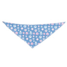 Dog bandana with pink and white paw prints and swirls on a blue background